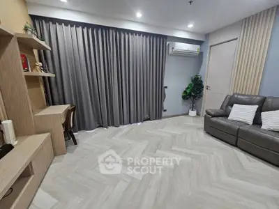 Modern living room with sleek furniture and stylish decor, featuring a cozy sofa and elegant shelving.