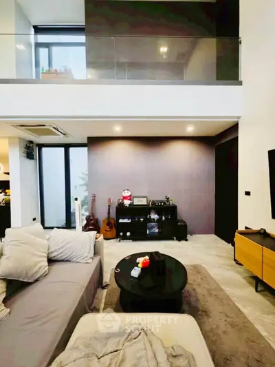 Modern living room with high ceiling and stylish decor