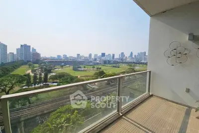 Spacious balcony with stunning city skyline and park views, perfect for relaxation and entertainment.