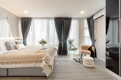 Luxurious modern bedroom with large windows and elegant decor
