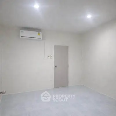 Minimalist unfurnished room with air conditioning and tiled floor, perfect for customization.