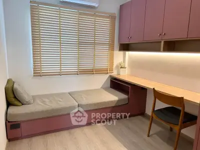 Cozy study room with built-in desk and seating, featuring modern cabinetry and natural light.