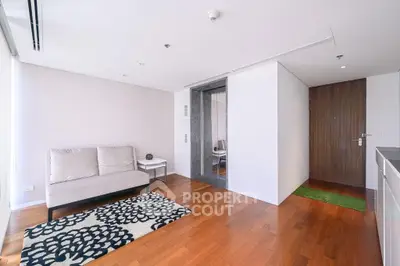 Modern living room with wooden flooring and stylish decor in a contemporary apartment.