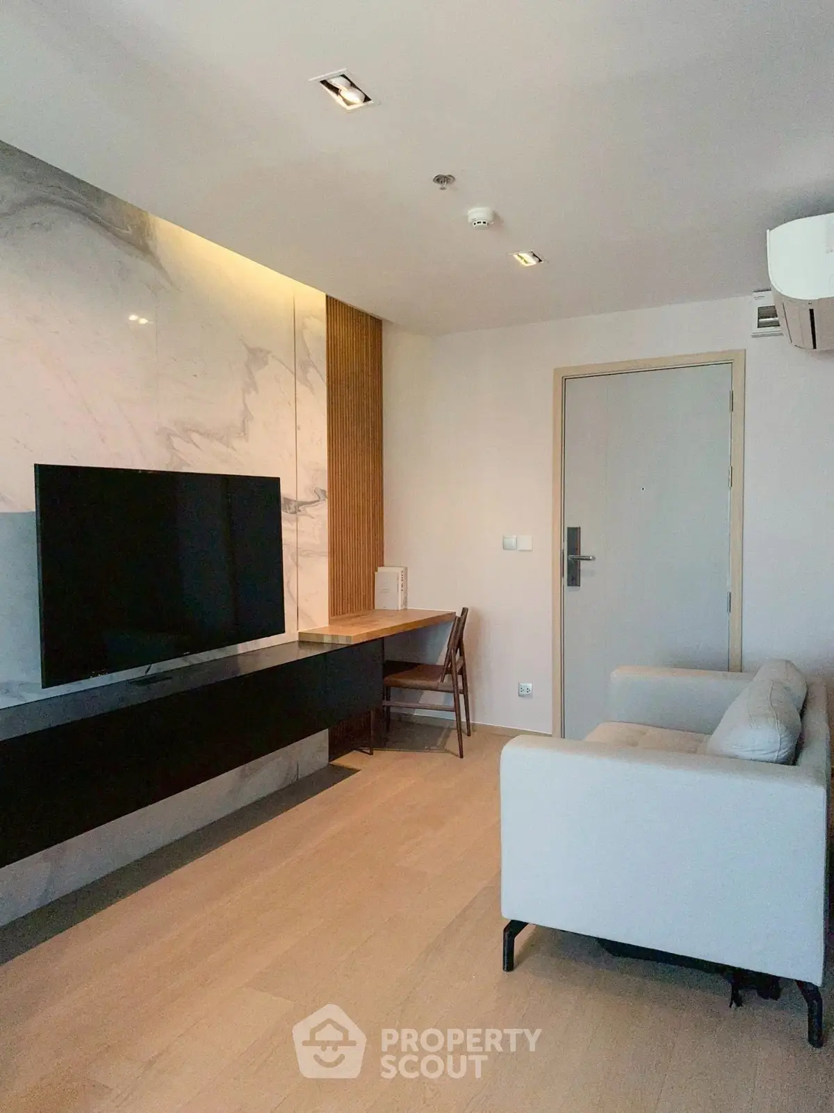 Modern living room with sleek TV setup and stylish marble accent wall