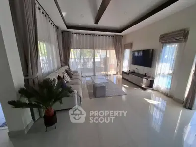 Spacious modern living room with large windows and elegant decor