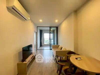 Modern living room with air conditioning and balcony view in a stylish apartment.