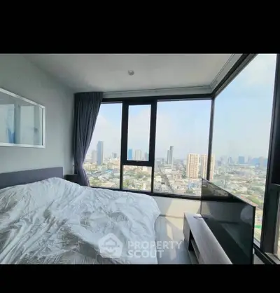 Stunning bedroom with panoramic city views and modern decor in high-rise apartment.