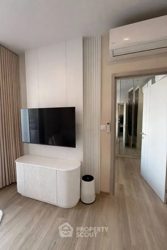 Modern living room with wall-mounted TV and sleek air conditioning unit