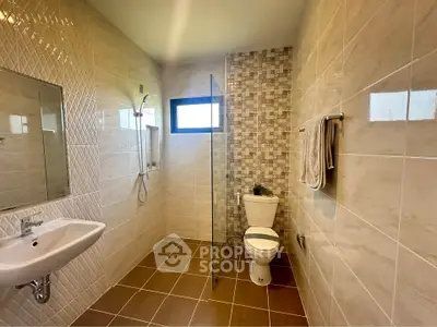 Modern bathroom with stylish tiles and glass shower partition