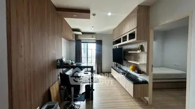 Modern apartment interior with open living room and bedroom, featuring sleek wooden finishes and natural light.
