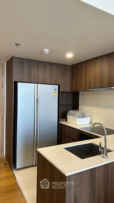 Modern kitchen with sleek wooden cabinets and stainless steel appliances