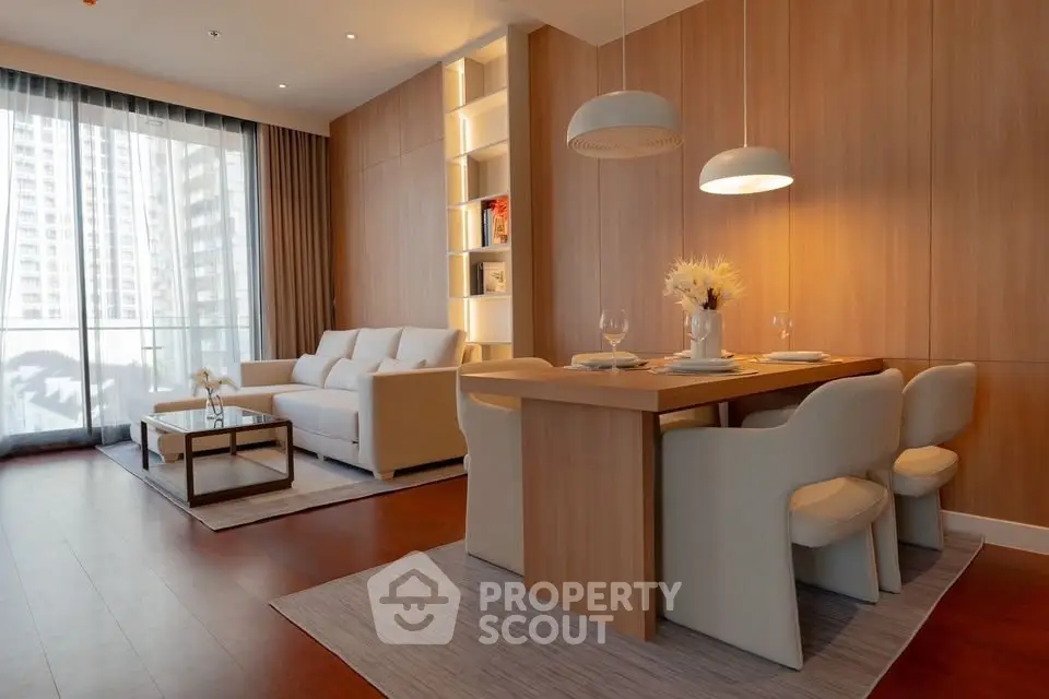 Elegant modern living room with dining area and large windows in a stylish apartment.