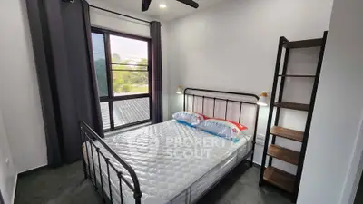 Modern bedroom with large window and stylish metal bed frame
