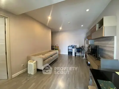 Spacious modern living room with sleek flooring and stylish furniture, perfect for comfortable living.