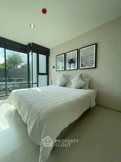 Bright and modern bedroom with large windows and stylish decor in a contemporary apartment.