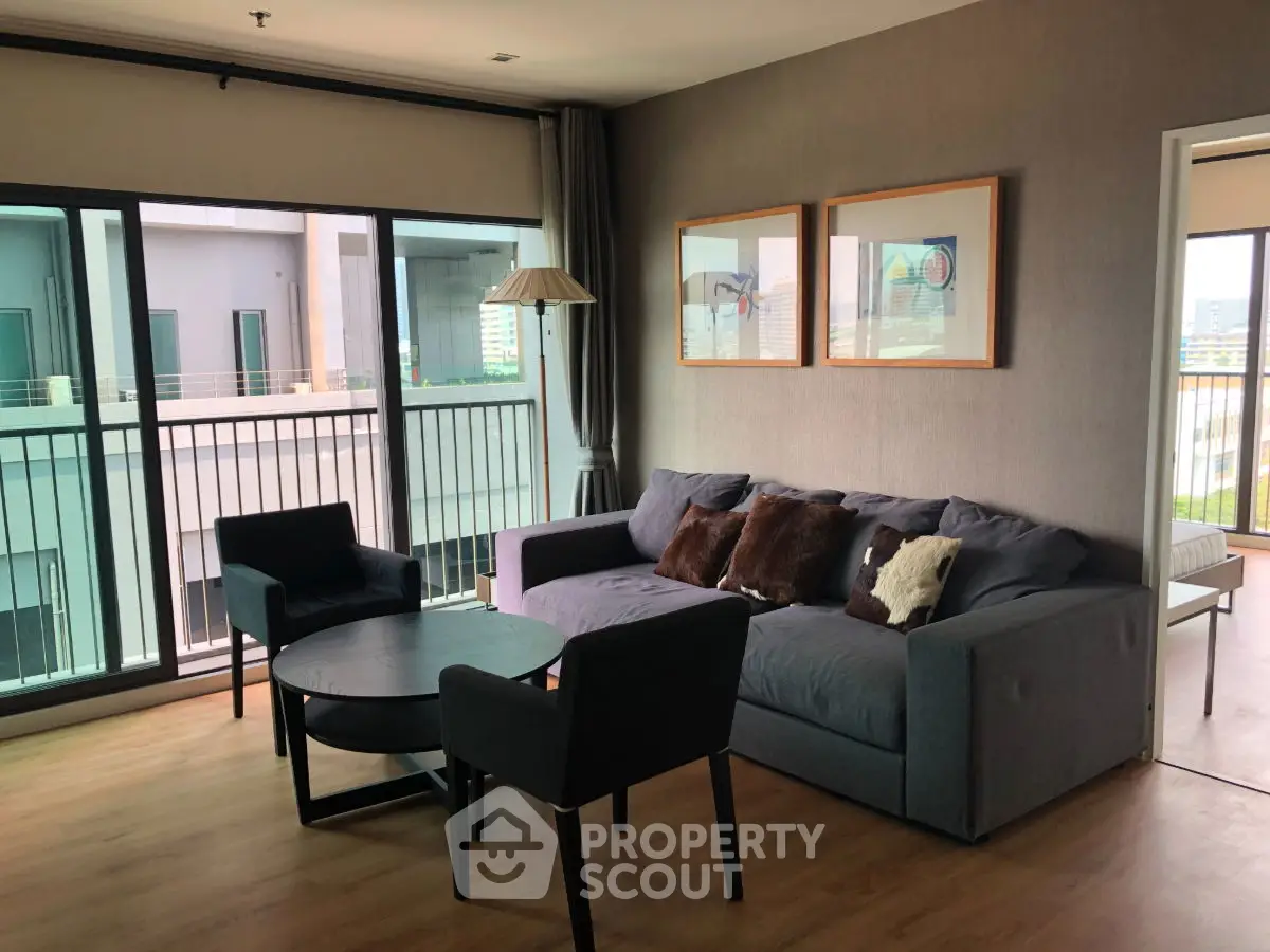 Spacious living room with modern furniture and balcony view