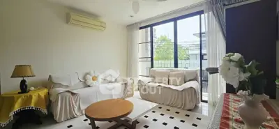 Bright and cozy living room with large windows and modern decor