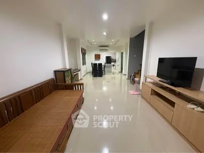 Spacious open-plan living room with modern furnishings and sleek design