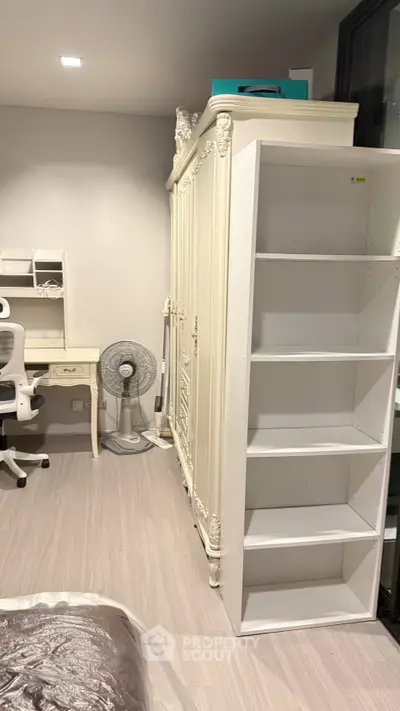 Elegant bedroom with classic wardrobe and modern study desk, perfect for a cozy and productive living space.