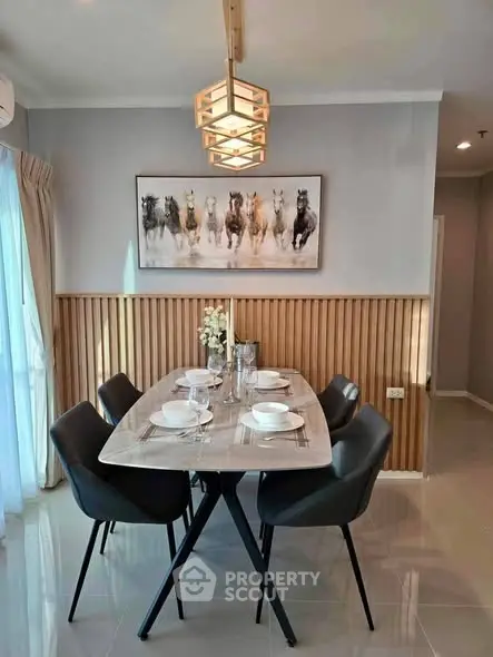 Modern dining area with elegant decor and stylish lighting in a contemporary home.