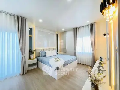 Luxurious bedroom with elegant decor and natural light, featuring stylish curtains and cozy bedding.