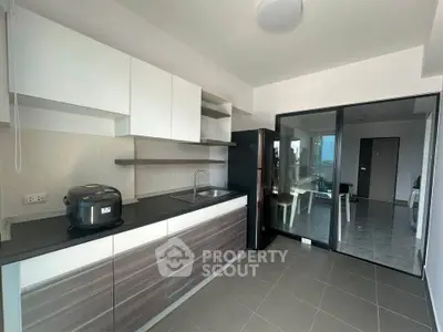 Modern kitchen with sleek cabinetry and appliances in a bright, open layout.
