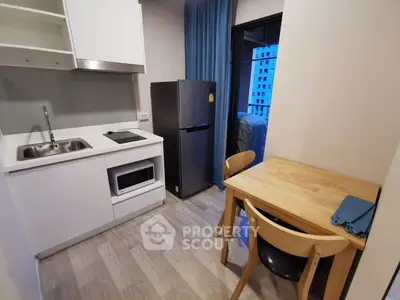 Modern compact kitchen with dining area in a cozy apartment