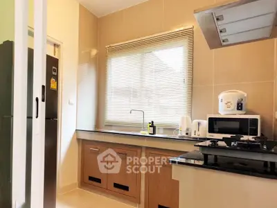 Modern kitchen with sleek appliances and ample natural light