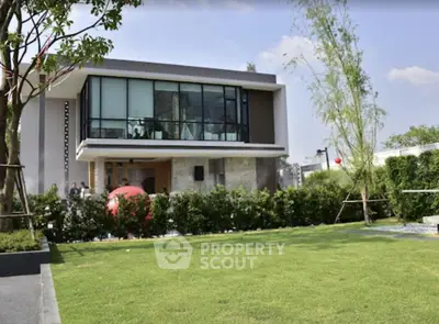 Modern luxury house with expansive lawn and glass facade