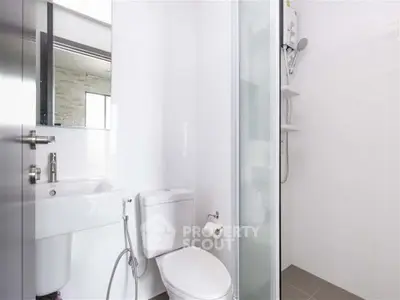 Modern bathroom with sleek fixtures and glass shower enclosure