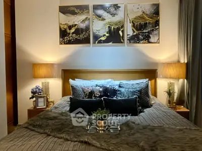 Luxurious bedroom with elegant decor and ambient lighting, featuring plush bedding and stylish artwork.