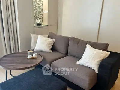 Cozy living room with modern sofa and stylish coffee table, perfect for relaxation.