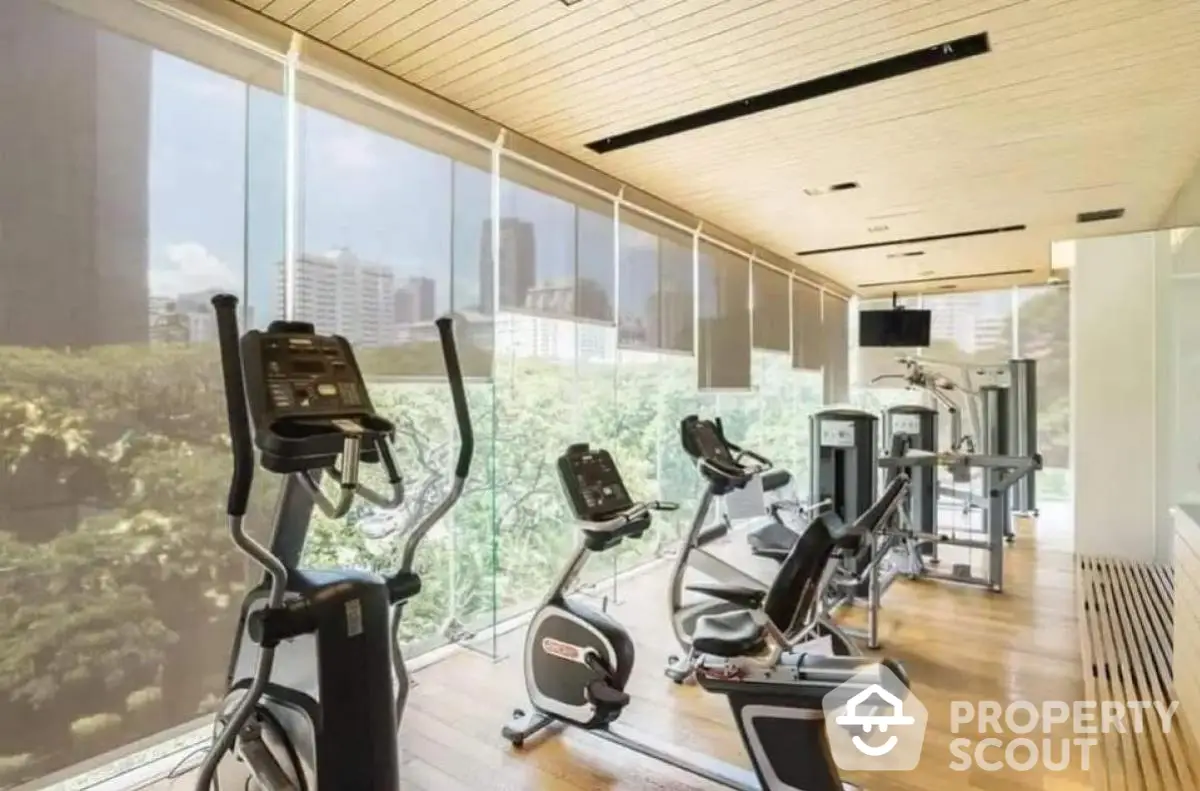 Modern gym with city view and state-of-the-art fitness equipment