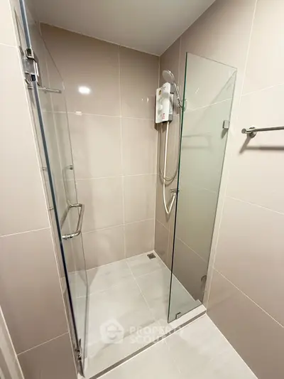 Modern bathroom with glass shower enclosure and sleek tile design