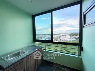Stunning balcony view with sleek kitchenette and panoramic cityscape.