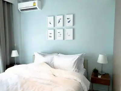 Modern bedroom with stylish decor and air conditioning, perfect for comfort and relaxation.