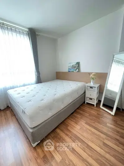 Bright and cozy bedroom with large window and stylish decor