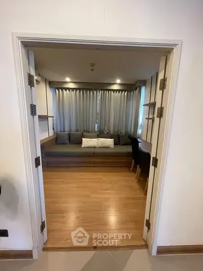 Cozy living room with wooden flooring and elegant curtains