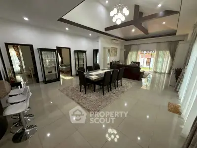 Spacious open-plan living and dining area with modern decor and ample natural light.