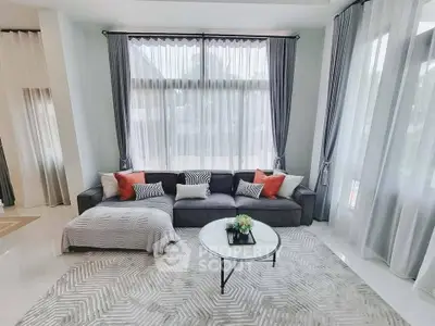 Spacious living room with elegant decor and large windows for natural light