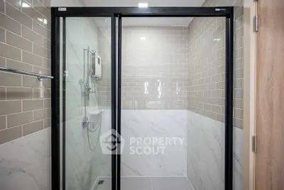 Modern bathroom with glass shower doors and stylish tile design