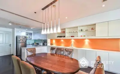 Modern kitchen with elegant dining area and stylish lighting