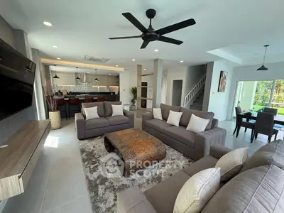 Spacious modern living room with elegant furniture and open kitchen layout