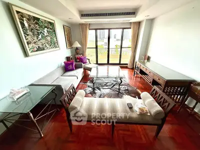 Spacious living room with elegant furniture and city view balcony