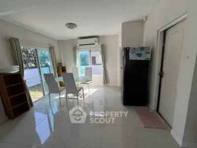 Bright living room with modern furniture and large windows in a stylish home.