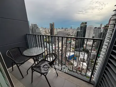 Stunning city view from a high-rise balcony with modern outdoor seating.