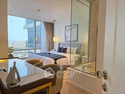 Luxurious bedroom with city view and elegant decor in high-rise apartment.
