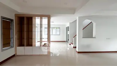 Spacious modern living room with built-in shelves and large windows