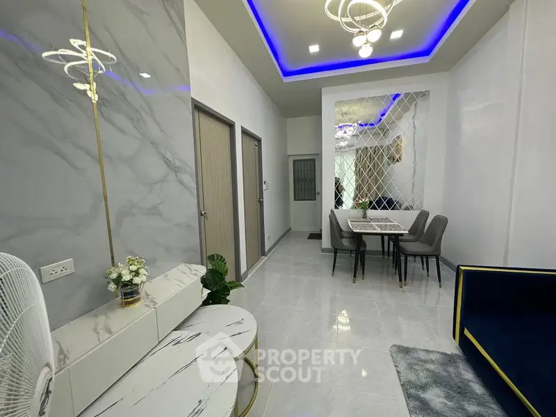 Modern living room with elegant marble accents and stylish dining area