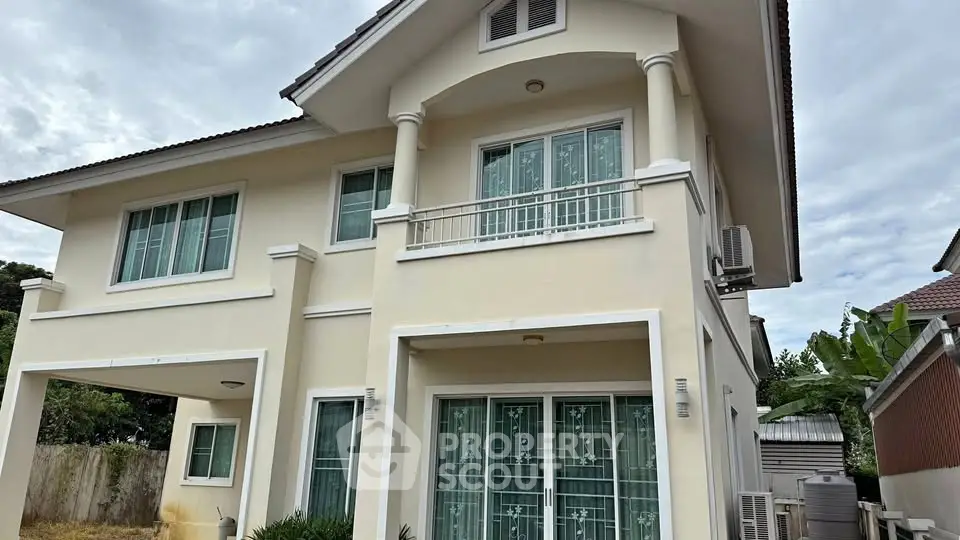 Elegant two-story house with modern design and large windows, perfect for family living in a serene neighborhood.